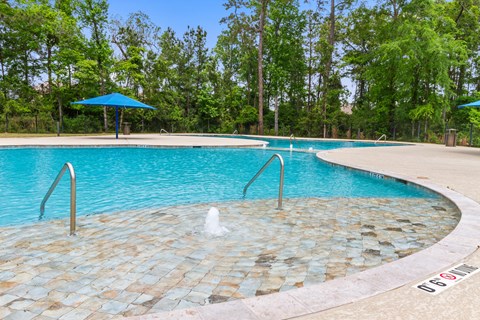 Homes for Rent with Attached Garage in Conroe, TX - Amber Pines at Foster's Ridge - Swimming Pool with Fountains, Umbrellas, Surrounded by Tall Trees
