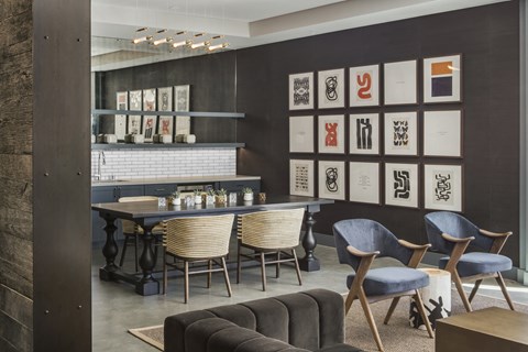 A modern dining room with a long table and chairs.