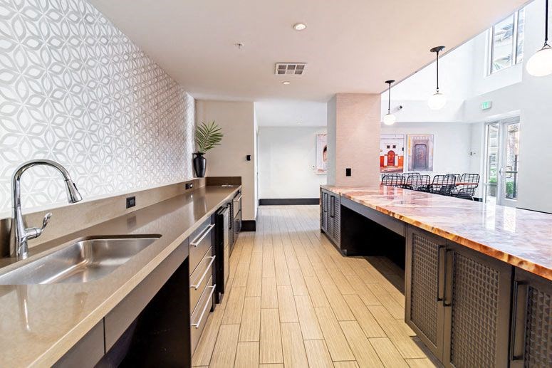 a large kitchen with a long counter and a sink