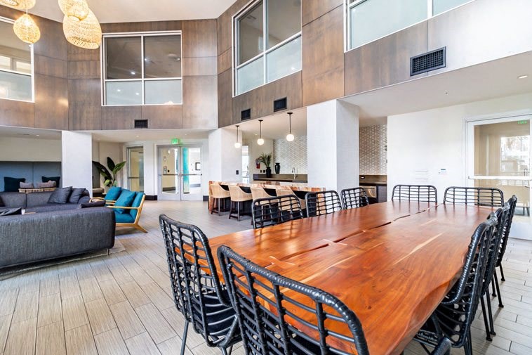 a large dining room with a long wooden table and chairs
