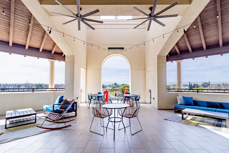 a large patio with chairs and tables and a view