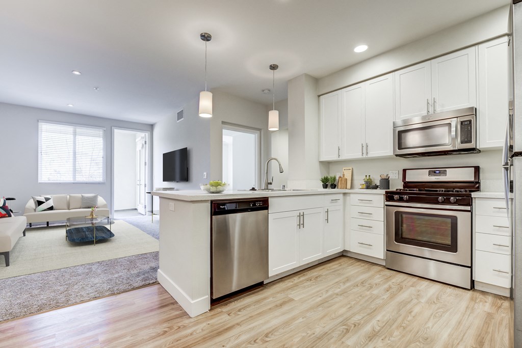Apartments in Milpitas, CA with In-Unit Washer and Dryer - Ilara Apartments - Kitchen with Modern White Cabinets, Stainless Steel Appliances, and a Breakfast Bar