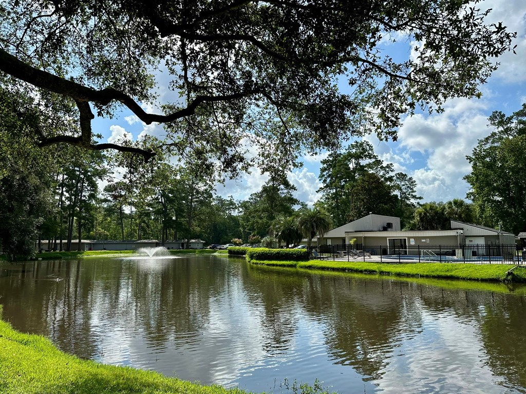 Addison Lane Apartments in Gainesville, Florida photo of lake with fountain and leasing office