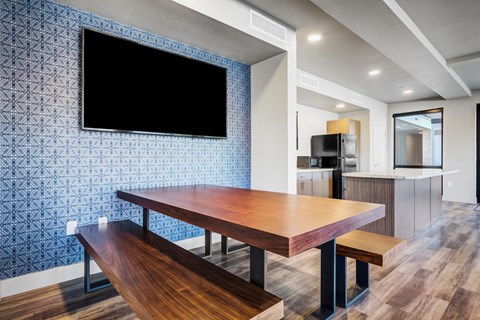 a dining room with a wooden table and a tv