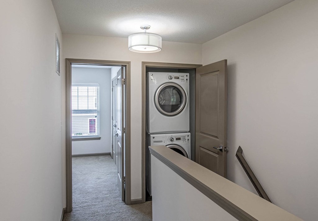 a bedroom with a washer and dryer in a 555 waverly unit
