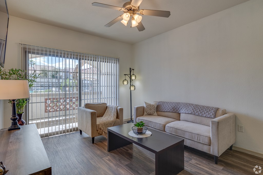 A living room with a couch, chair, and table.