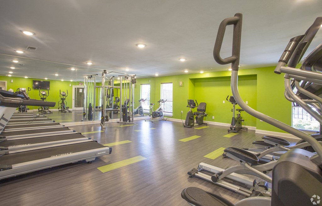Two-Bedroom Apartments in Fort Worth, TX- Monarch Pass- Fully Equipped Gym with Green Walls and Wood-Style Floors