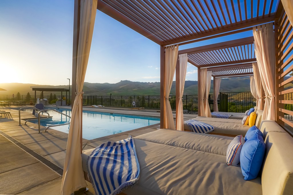 A sunny day at the pool with a view of the mountains.
