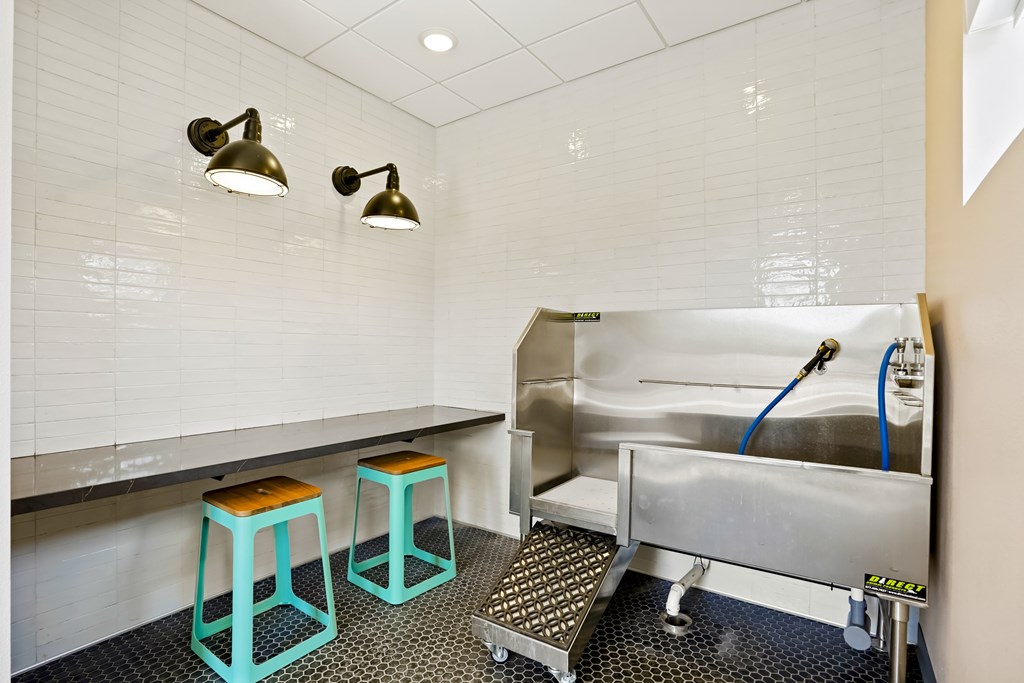 A kitchen with a sink and bar stools.