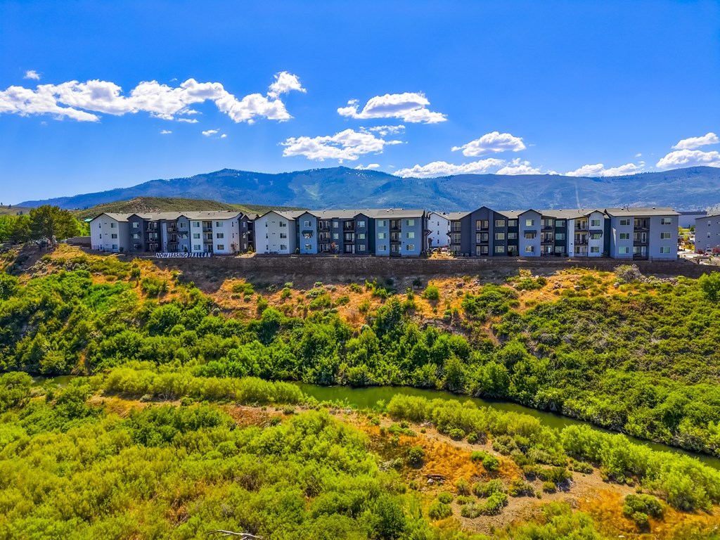 A row of houses are built on a hillside.