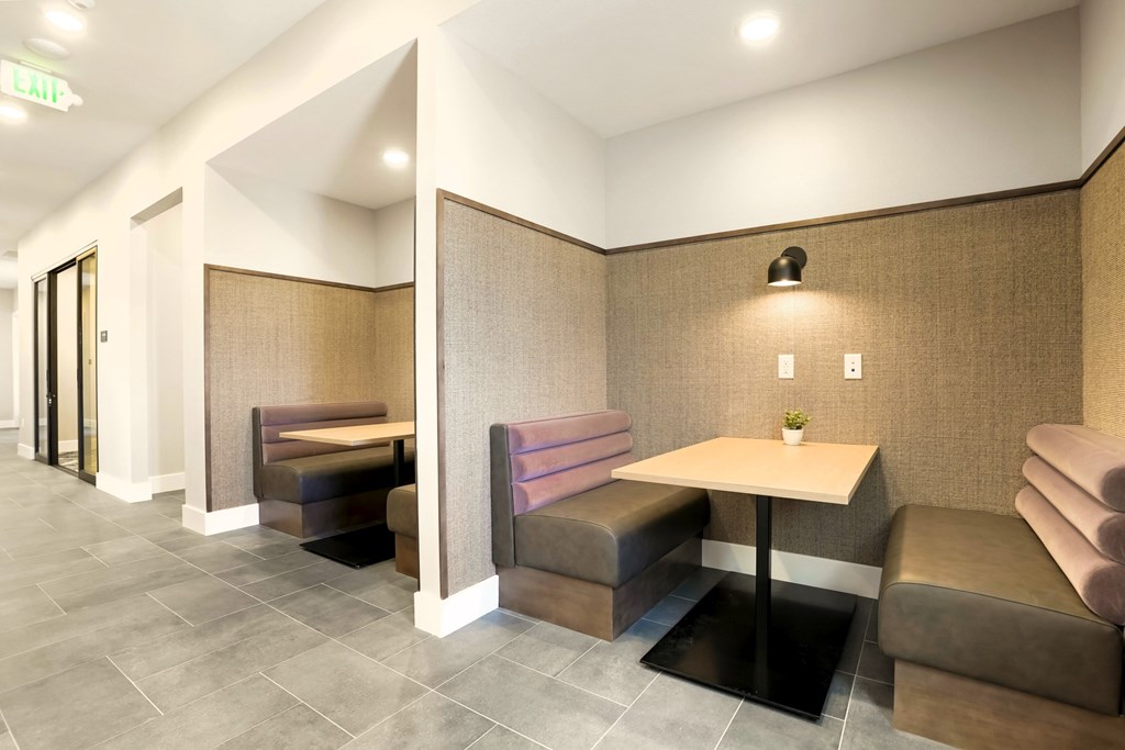 A room with a table and chairs in the middle.