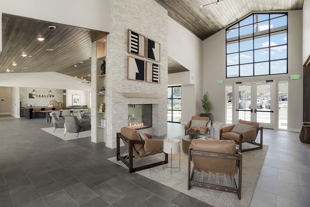 A spacious living room with a fireplace and a large window.