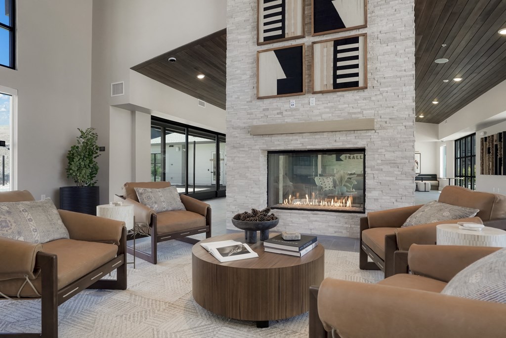 a living room with couches and chairs and a fireplace
