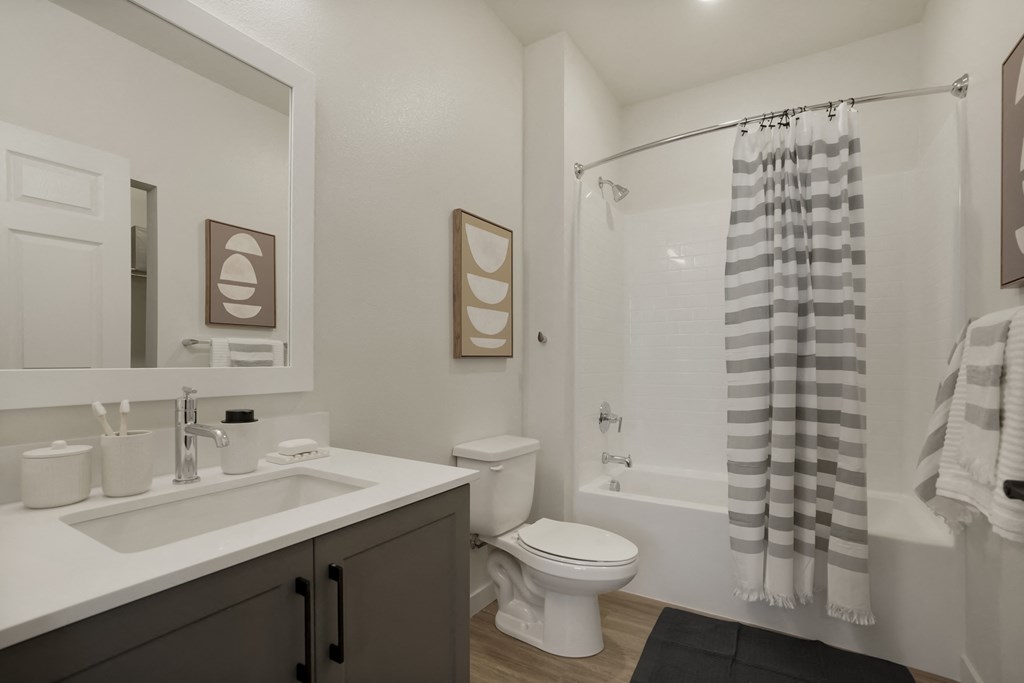 a bathroom with a shower and a sink and a toilet