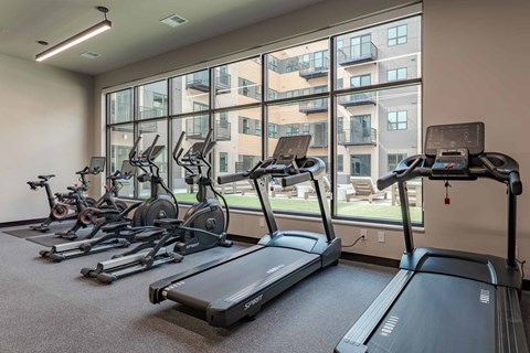 A gym with treadmills and exercise bikes.