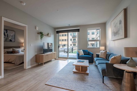 A living room with a grey couch and a wooden coffee table.