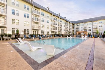 Resort pool with chair wading area and fountain feature - Photo Gallery 32