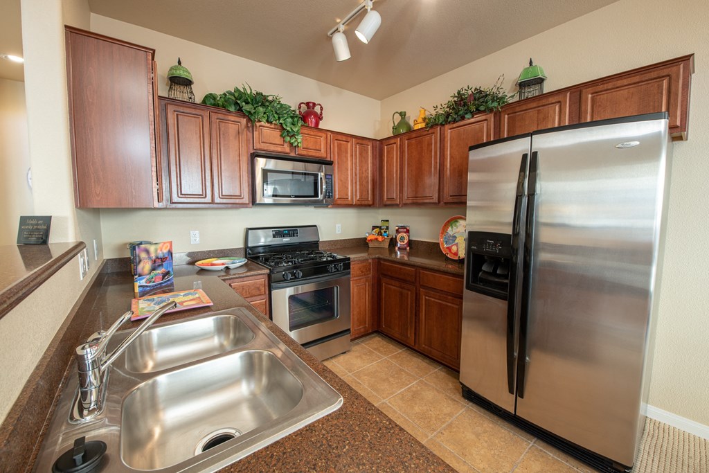 a kitchen with stainless steel appliances and wooden cabinets