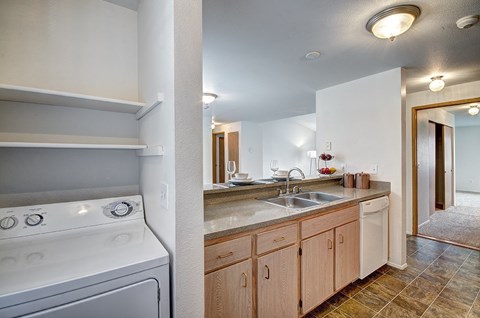 A white oven is in a kitchen with wooden cabinets.