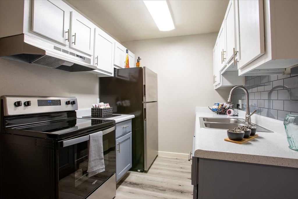 a kitchen with stainless steel appliances and white cabinets