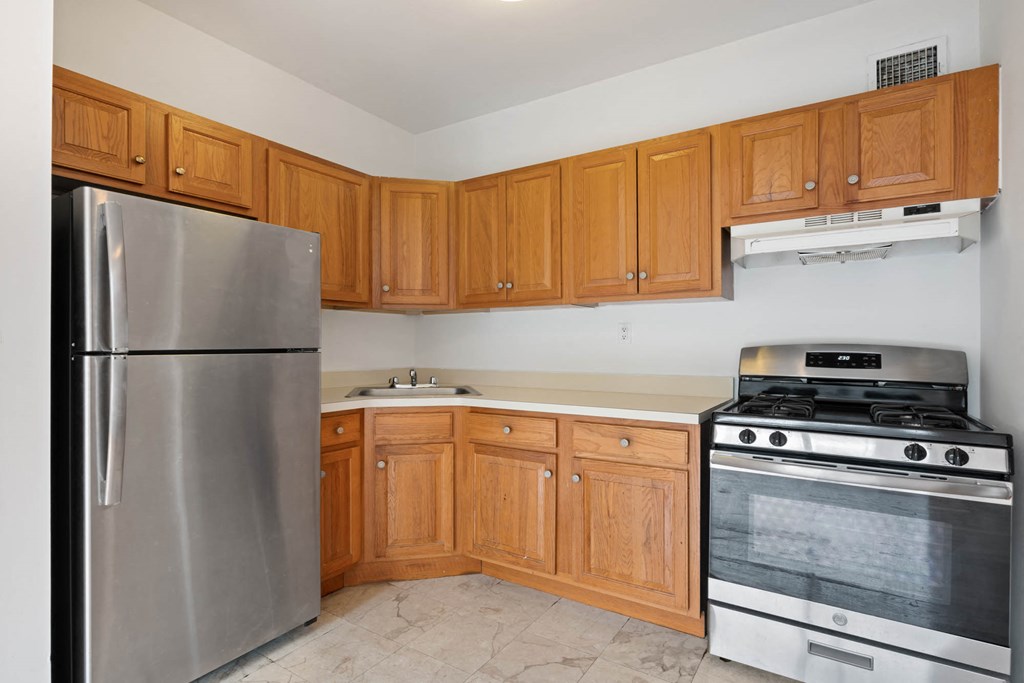 a kitchen with stainless steel appliances and wooden cabinets