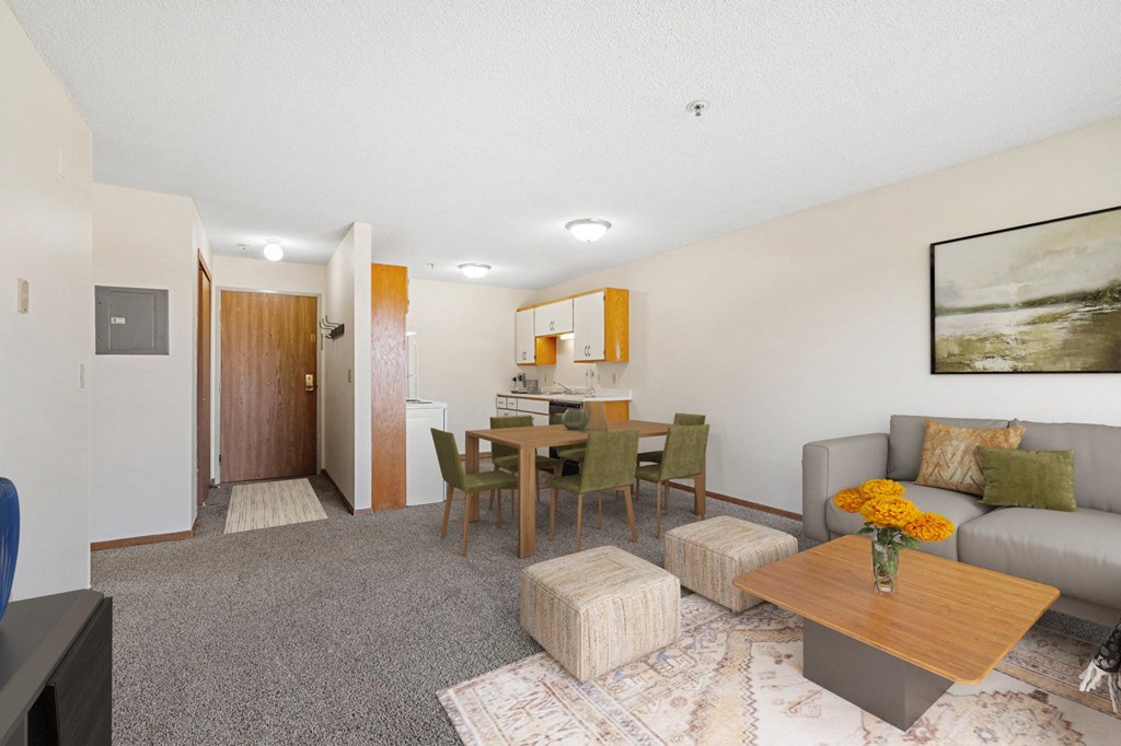 a living room with a couch and a dining room table