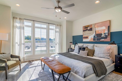 Luxury Atlanta, GA Homes – LaFrance Square – A bedroom with a large bed and a ceiling fan.