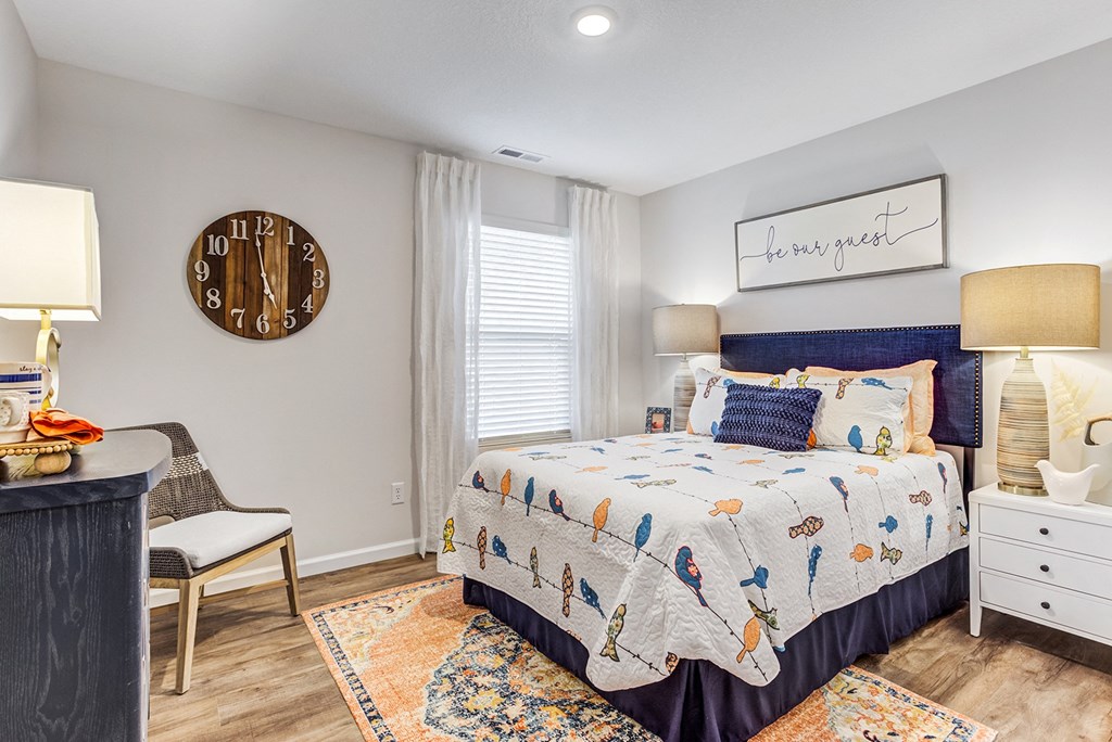 a bedroom with a bed and a desk