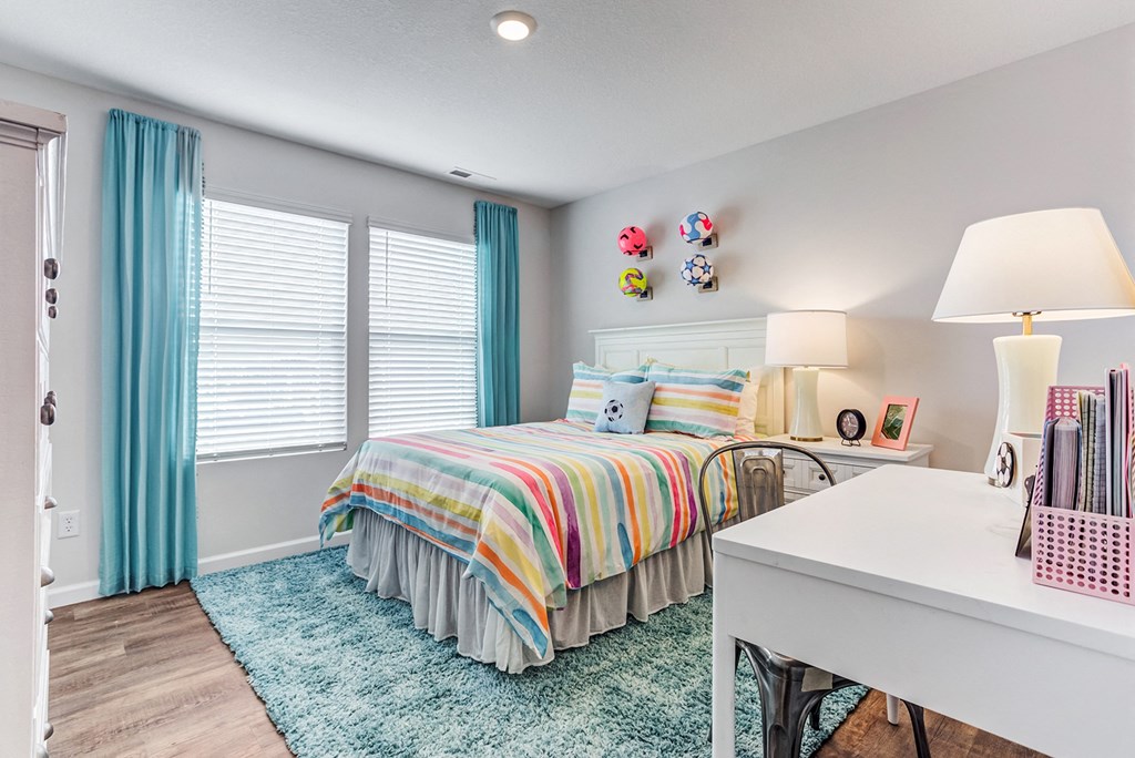 a bedroom with a bed and a desk