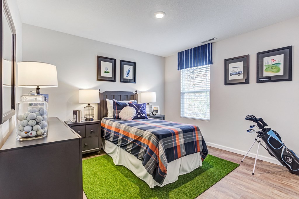 a bedroom with a bed and a bike on a green rug