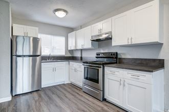 Landings at Parkview apartments in Jacksonville Florida photo of a kitchen with white cabinets and stainless steel appliances