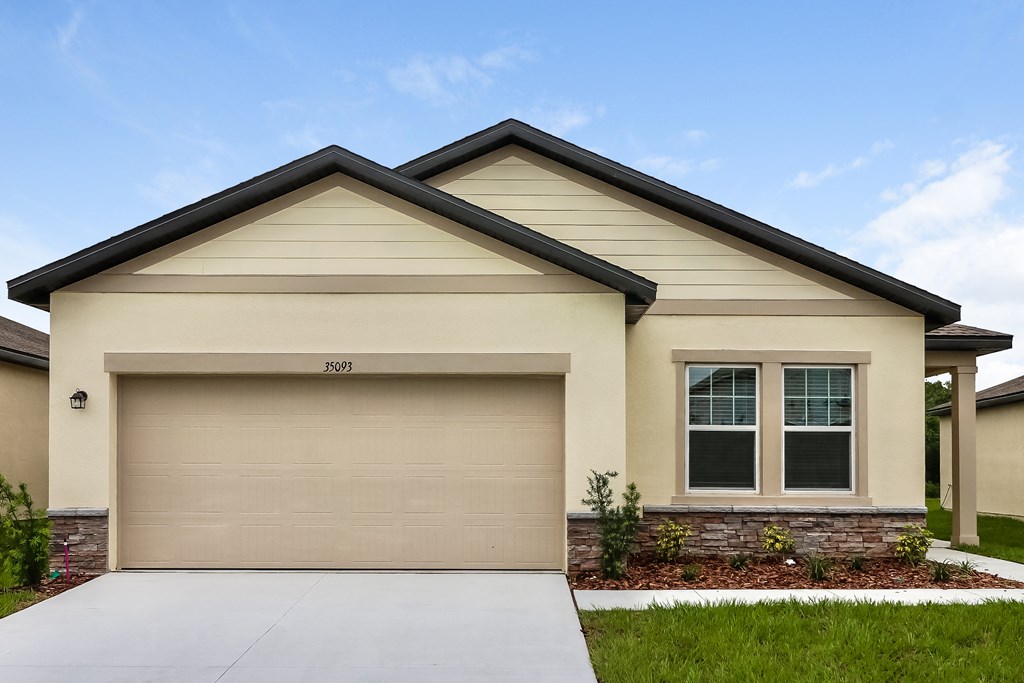 A beige house with a garage door that says 3509.