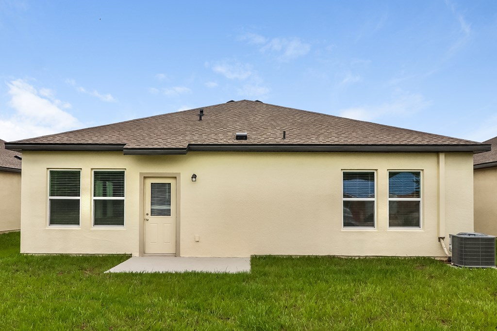 A house with a brown roof and a white door.