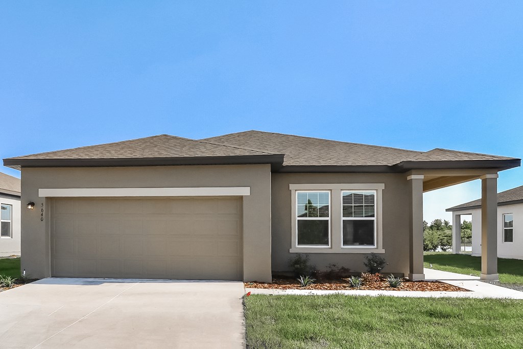 A house with a garage door and a window.