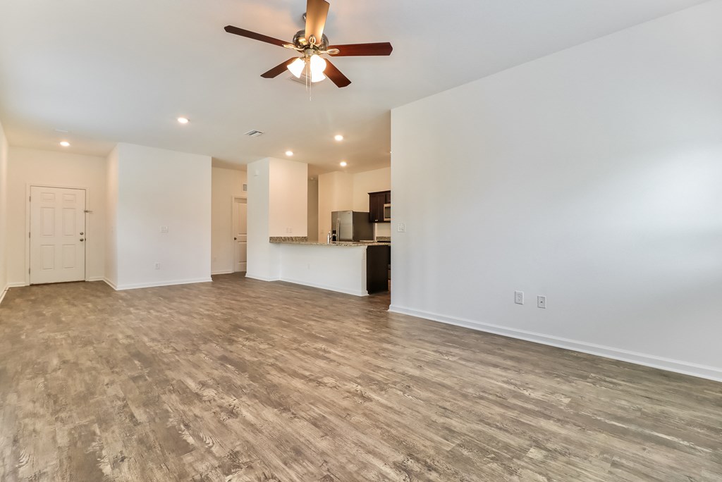 A room with a ceiling fan and lighting fixtures.