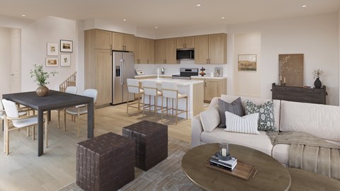A modern living room with a kitchen in the background.