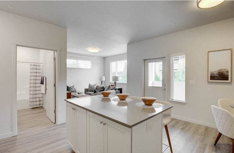 a kitchen with an island and a living room