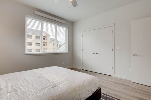 a bedroom with a bed and a window