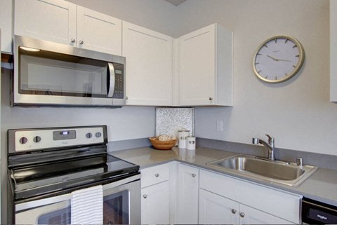 a kitchen with a microwave oven and a sink