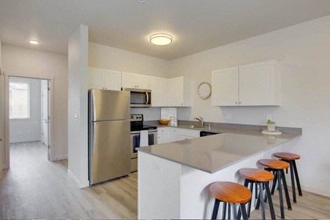 a kitchen with an island and bar stools