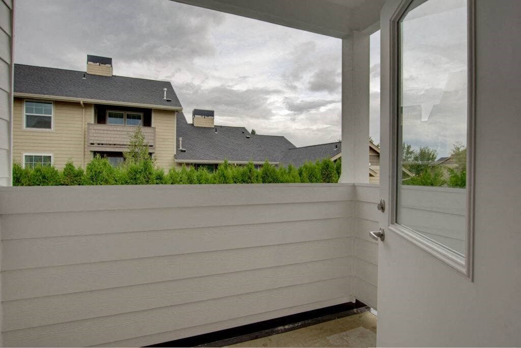 a view of a house from a porch with a glass door