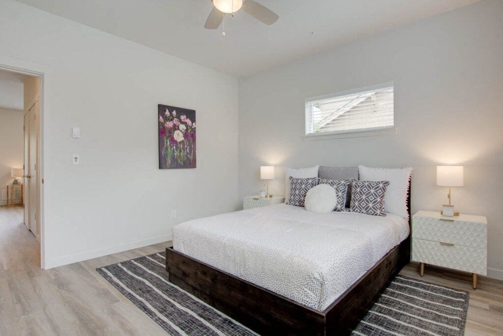 a bedroom with a bed and a ceiling fan