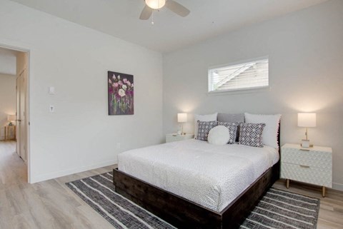 a bedroom with a bed and a ceiling fan