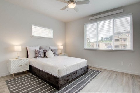 a bedroom with a bed and a ceiling fan