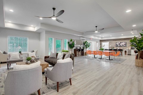 a spacious living room with couches and chairs and a dining room with a bar