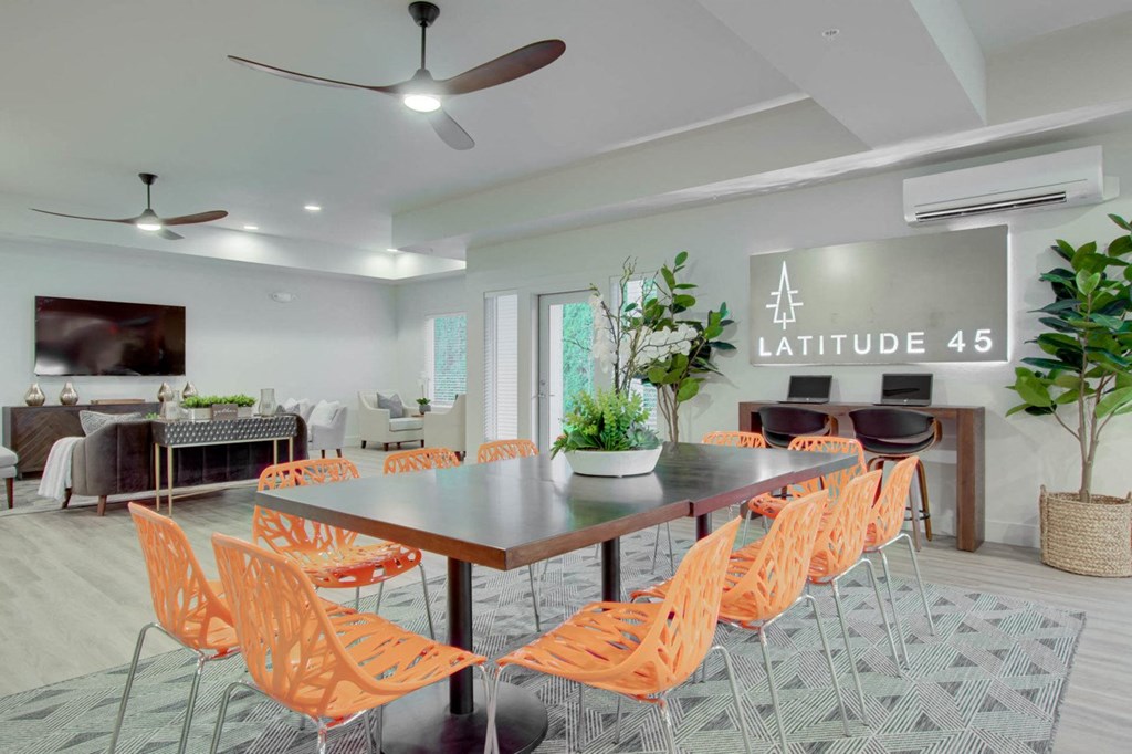 a dining room with orange chairs and a table