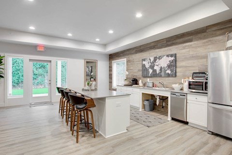 a kitchen with a bar and a refrigerator