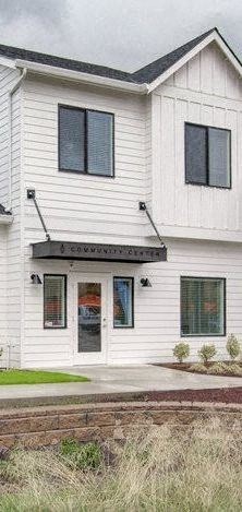 a white house with black windows and a door