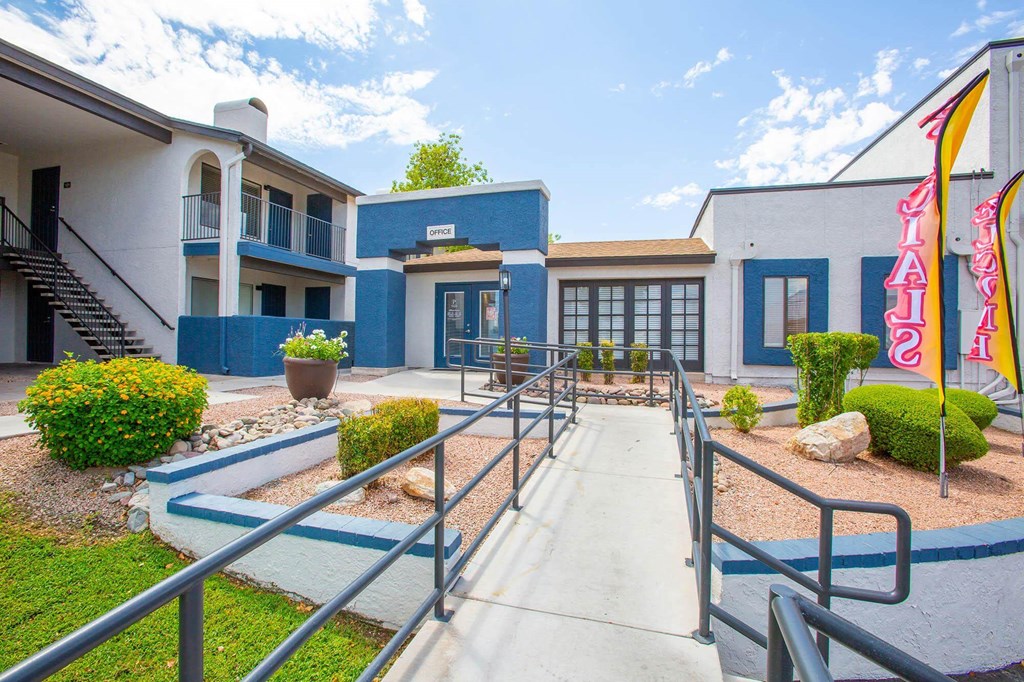 a building with stairs and a walkway leading to it
