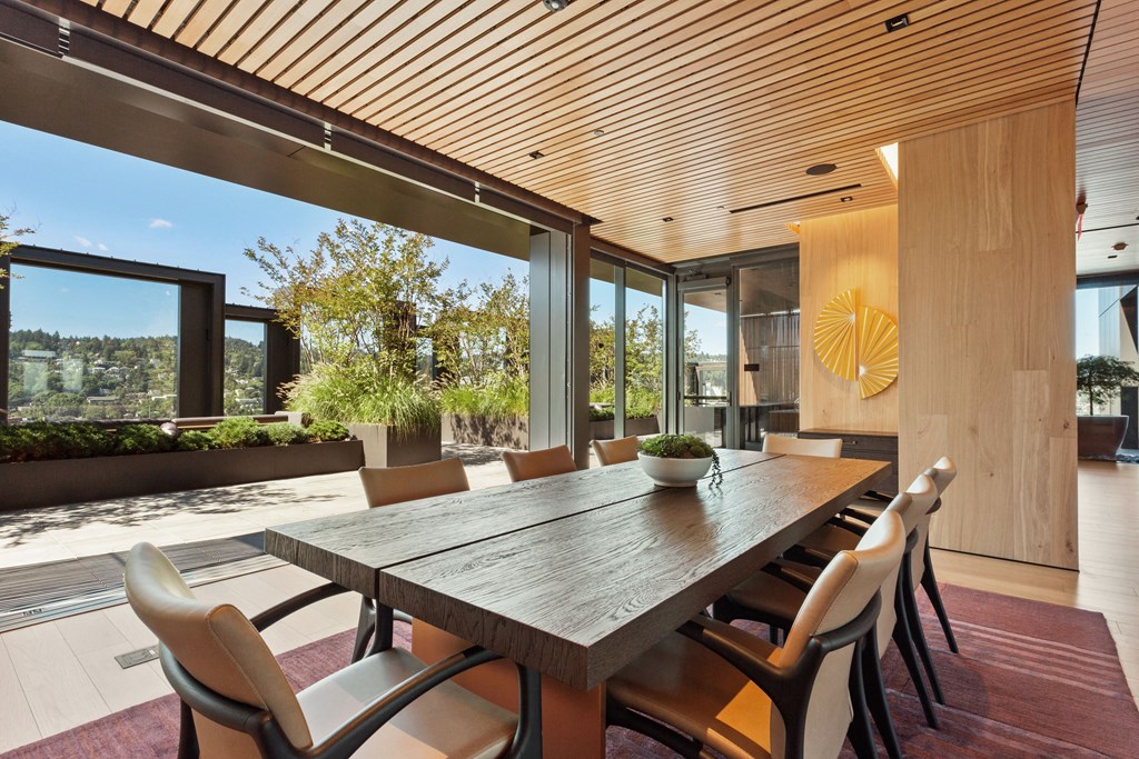 a dining room with a wooden table and white chairs